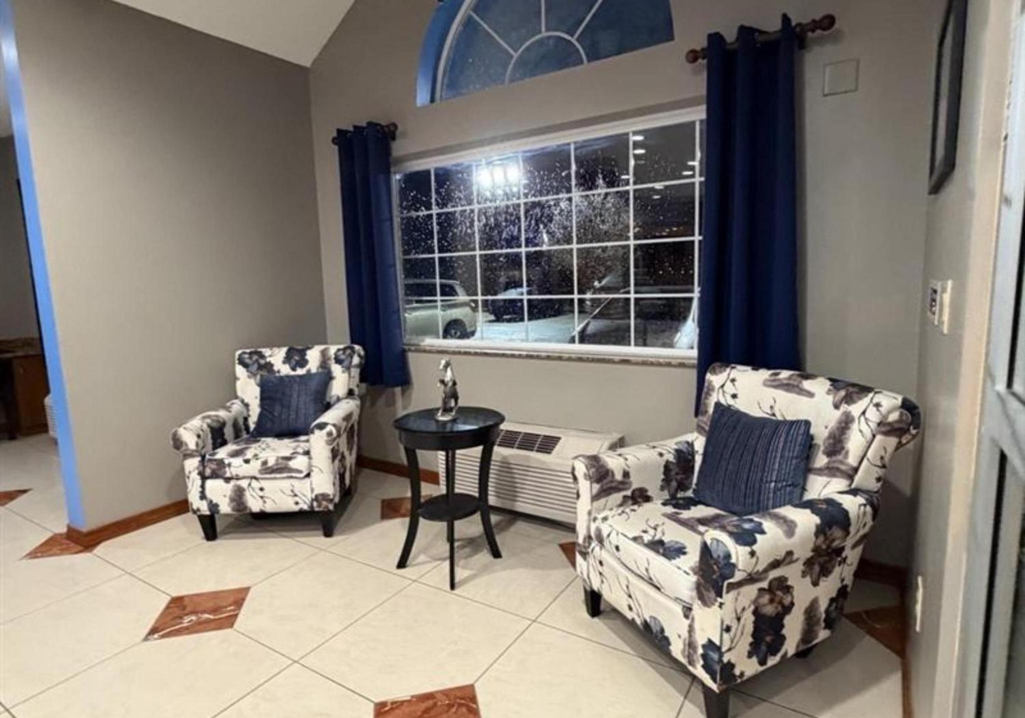 Patterned armchairs by the hotel lobby window